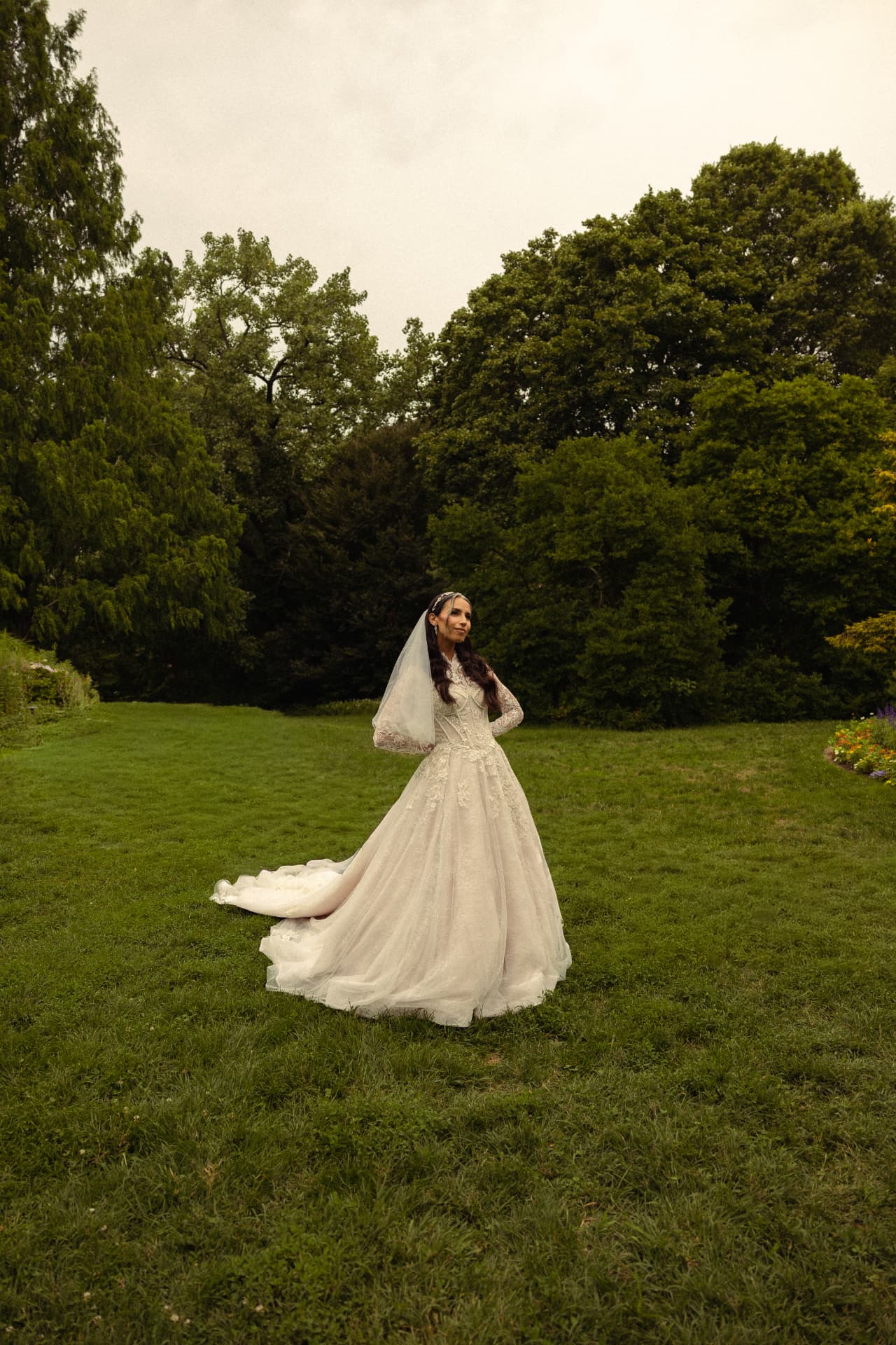 a bride alone in a wide green field